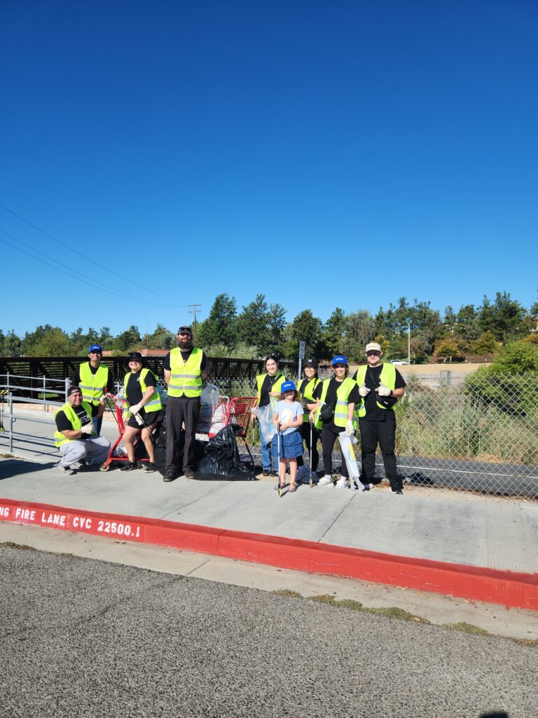 volunteers in safety vests at the side of the road.
